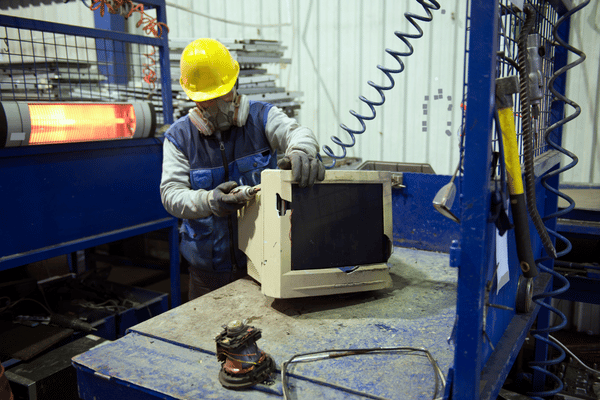 A person destroying a computer in a facility