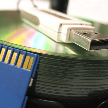 Close up of electronic media devices like thumb drives, SD Cards and CDs